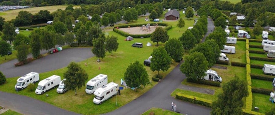 campers en caravans op ee ngroen kampeerterrein